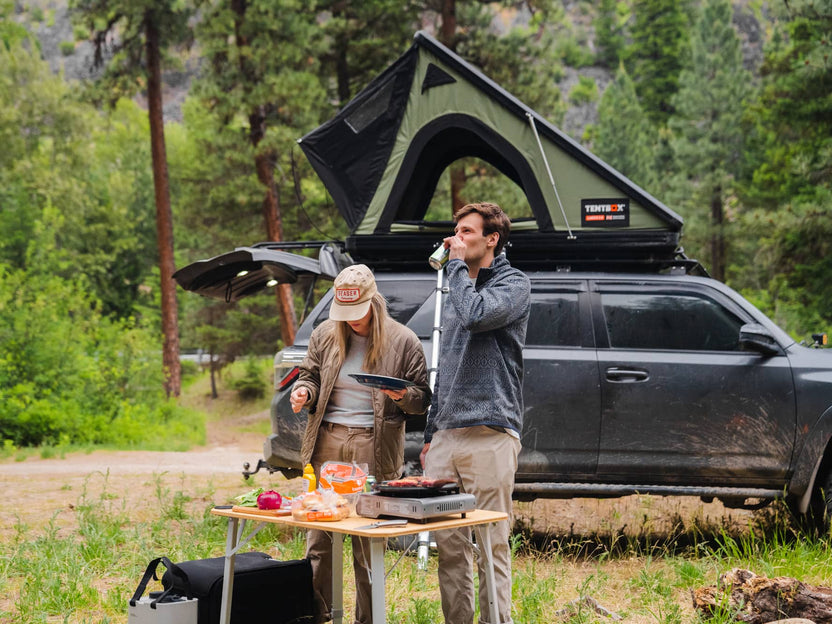 Couple enjoying camping in Montana with their TentBox Cargo 2.0 in Forest Green