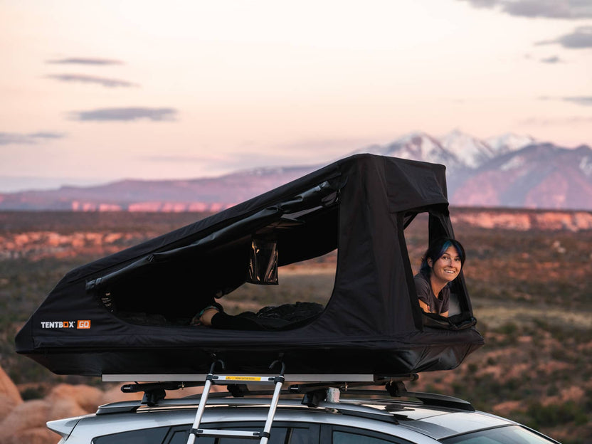 Woman relaxing inside the TentBox GO whilst enjoying the sunset views in Utah