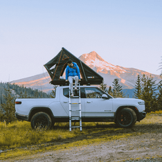 TentBox Cargo roof tent installed on Rivian truck in USA mountain camp site