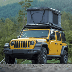 TentBox Classic roof tent installed on yellow Jeep Wrangler Rubicon in USA woodland scene