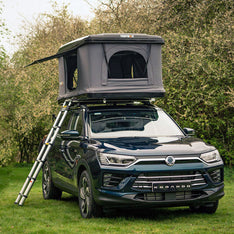 A TentBox Classic 1.0 installed on a Black SUV parked in a field