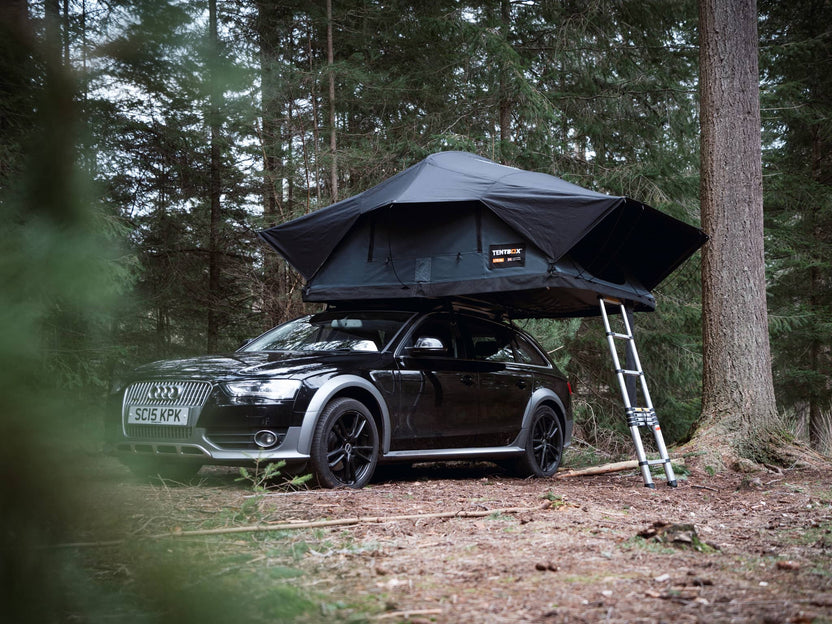 Slate grey version of TentBox Lite XL roof tent in woodland camping scene